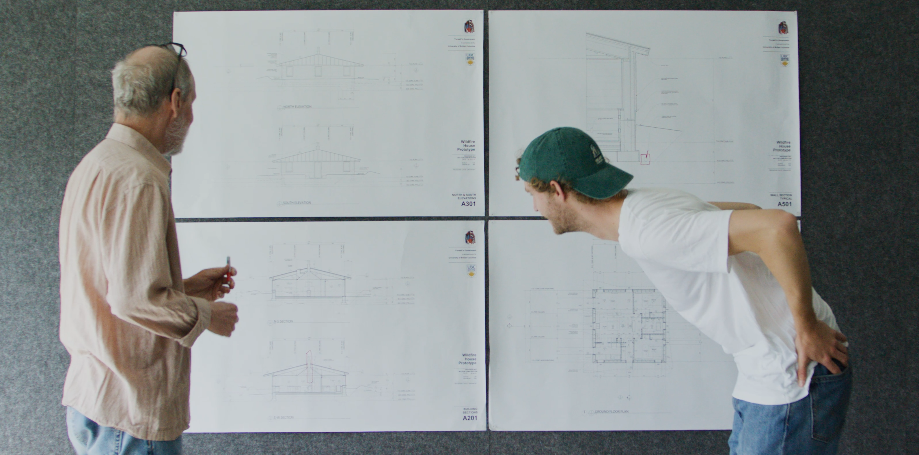Two people standing in front of project 