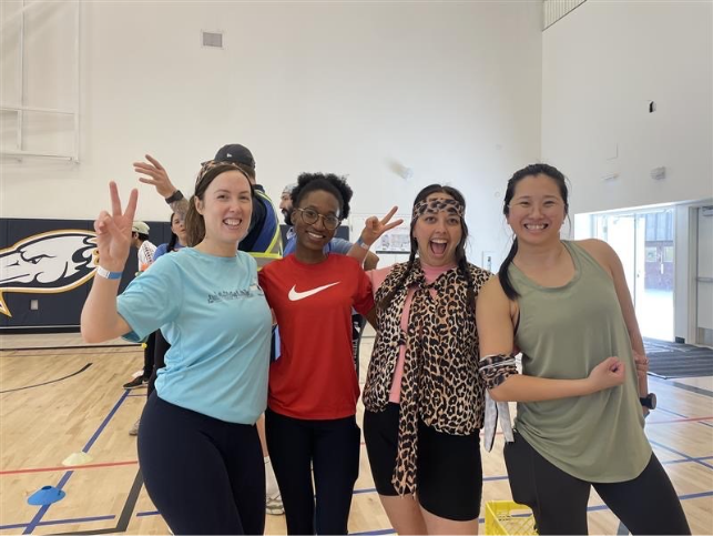 4 people standing in gym
